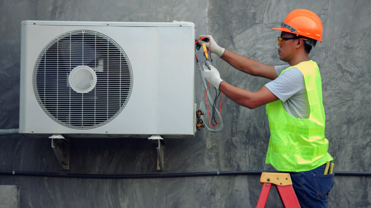 man fixing heat pump