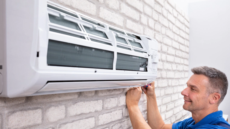 man installing new air conditioner