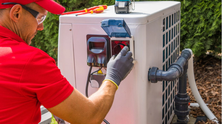 man installing pool heater