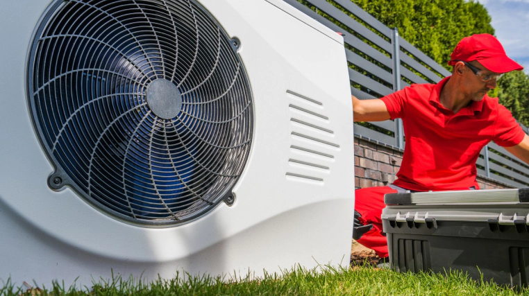 worker installing pool heaters